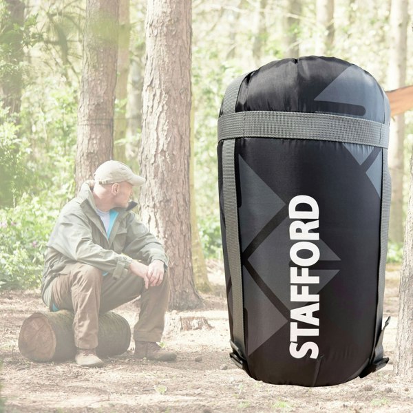 An image of the OLPRO X Stafford sleeping bag in grey with Ed Stafford as the back drop.