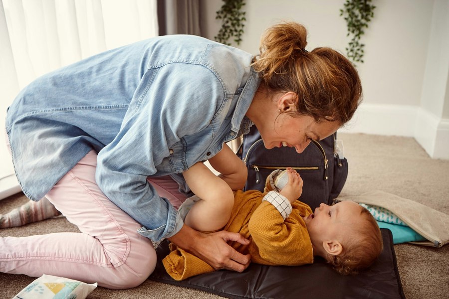 padded waterproof baby changing mat with baby laying on top