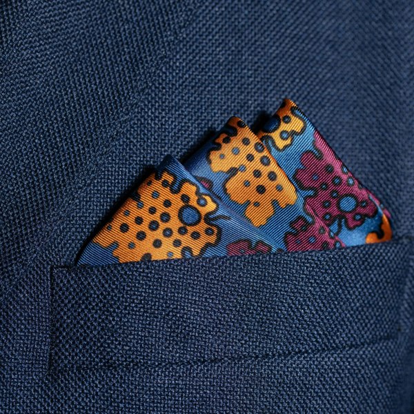 Leaf design silk pocket square in blue, burgundy & gold by Otway & Orford folded in top pocket