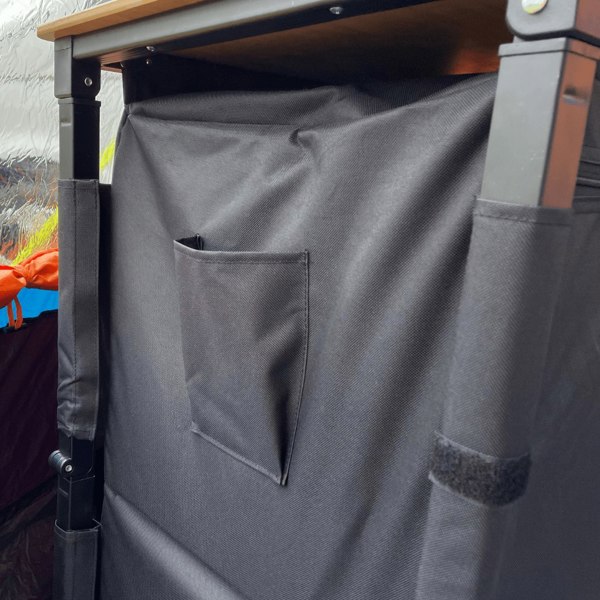 The OLPRO Bamboo Cooking Table with the doors closed in a campervan awning.