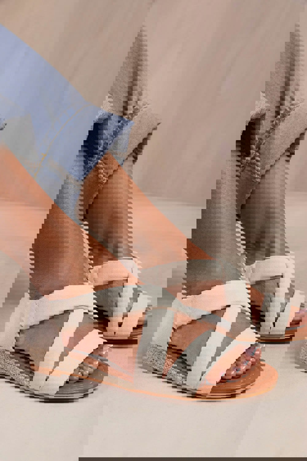 Where's That From Hummingbird Wide Fit Low Wedge Shoes With Cross Over Strap in Light Cream Suede