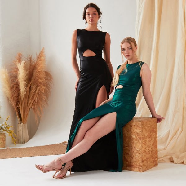 Two women wearing the Sarvin Cut Out Side Dress, one in black and one in the green variation