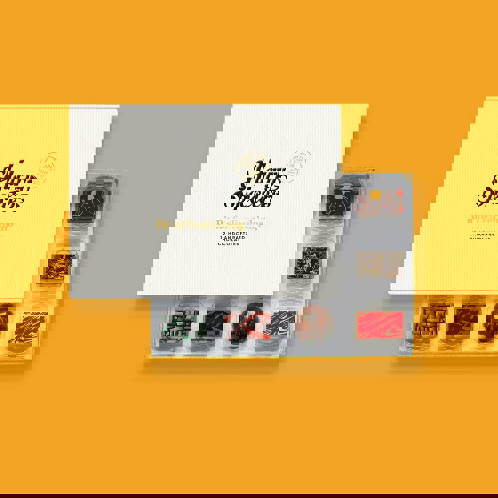 A box of 12 artisan chocolates by Harry Specters partially covered by a box lid 