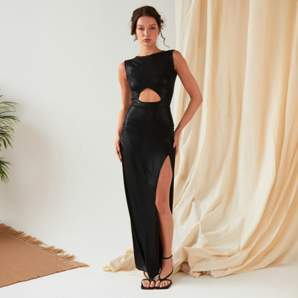 The model is wearing a Sarvin Black Cut Out Maxi Dress with a slit.