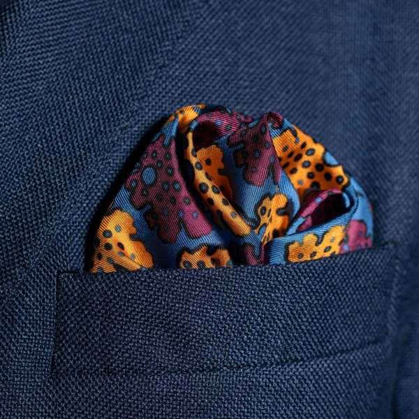 Leaf design silk pocket square in blue, burgundy & gold by Otway & Orford folded in top pocket