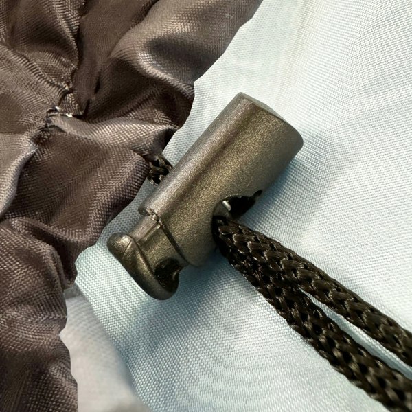 A closeup image of the drawstring toggle of the OLPRO X Stafford Sleeping Bag