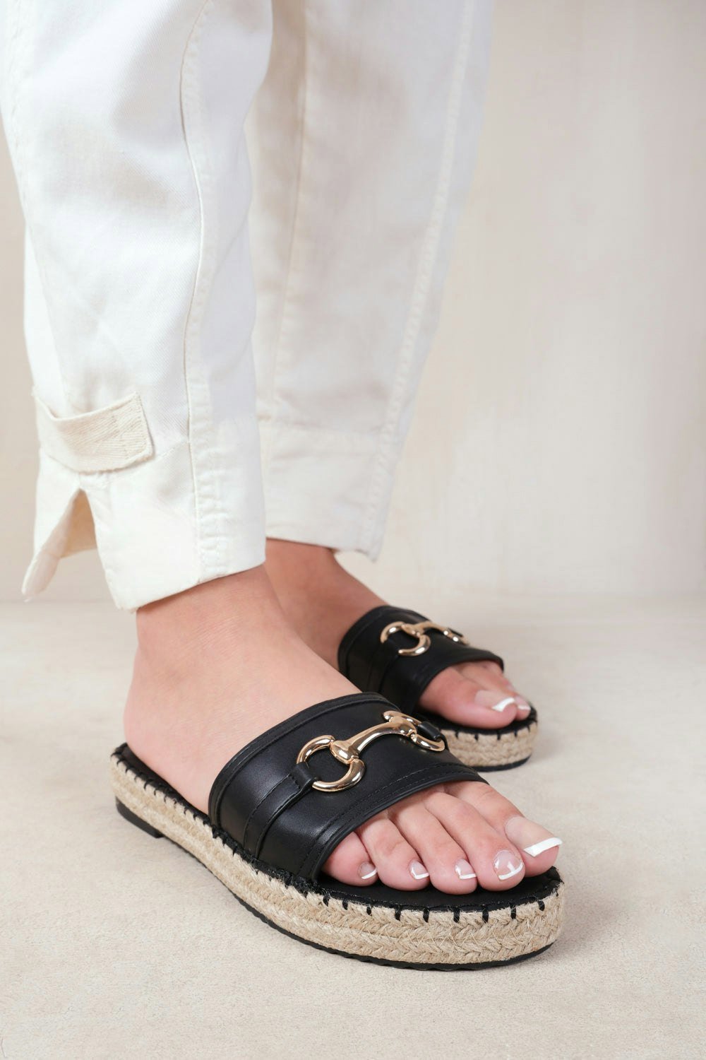 Where's That From Jupiter Single Strap Flat Sandals With Thread Design and Golden Detailing in Black