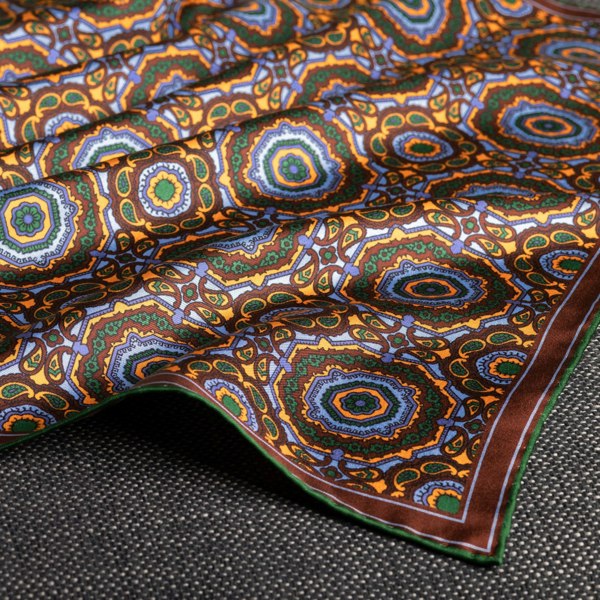 Whirligig medallion silk pocket square in blue, orange, brown & green by Otway & Orford