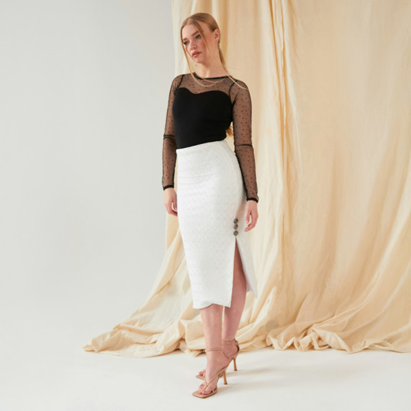 The model is wearing a Sarvin White Lace Bodycon Skirt and a black top.