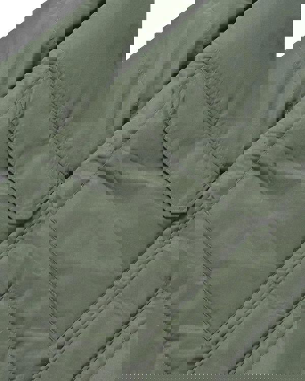 Lambretta Mens Padded Hooded Classic Badge Parka, close-up view of the olive green padded parka featuring a large flap pocket on the front.