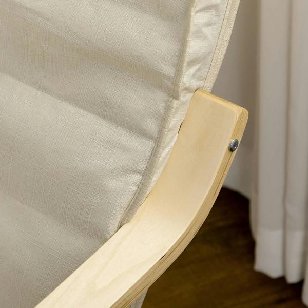 Detail of cream cushion corner on a light wood lounge chair armrest