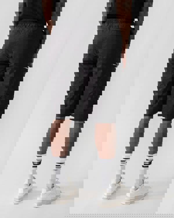 Model wearing Moose Knuckles Topflight Mens Cargo Shorts in Black 292 - back