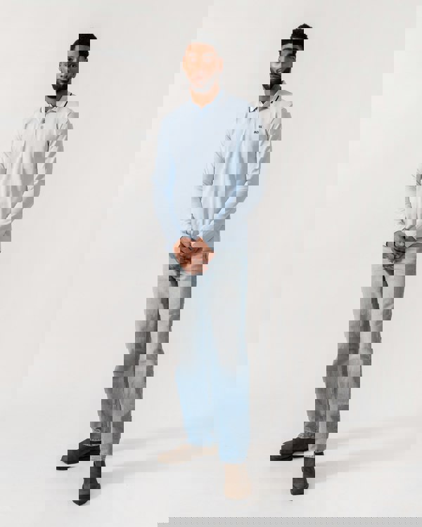 Model wearing BOSS Green Mens Plisy Long Sleeve Polo Shirt in Open Blue 464 - Full Length