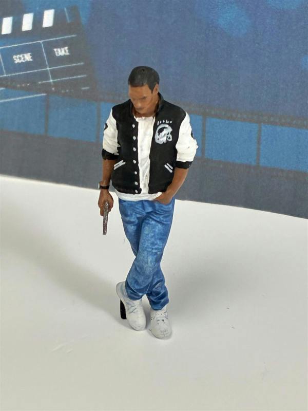 a toy figurine of a man holding a gun