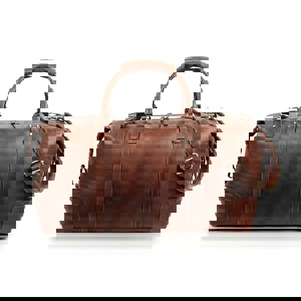 Side view of the brown leather holdall, featuring its durable zippers and side attachments for the shoulder strap.