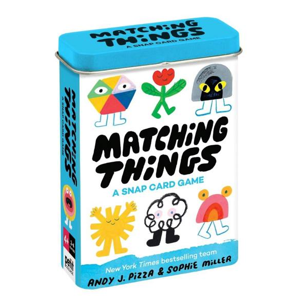 The compact blue and white metal storage tin for the Matching Things snap card game, featuring colourful character illustrations by Andy J. Pizza and Sophie Miller.