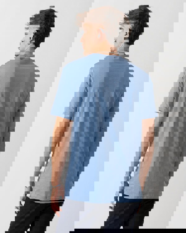 back detail of a Model wearing a GANT Mens Regular Fit Short Sleeve Shield Logo T-Shirt in Faded Denim