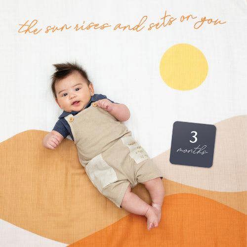 Lulujo - Baby's First Year Gift Set -  Cotton Swaddle & Cards - Sun Rises