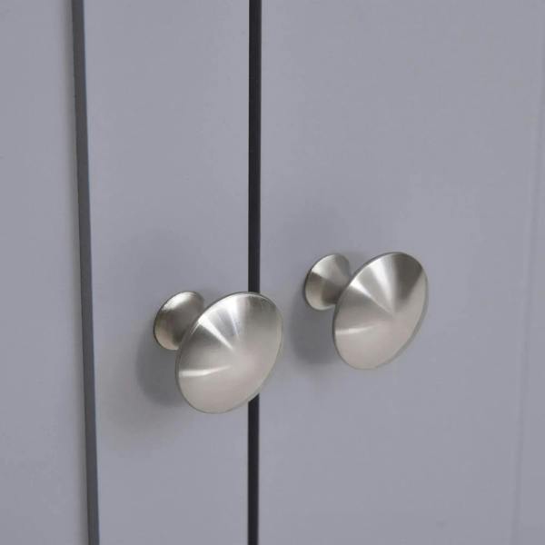 Close-up of round silver knob handles on two grey doors of an under-sink cabinet