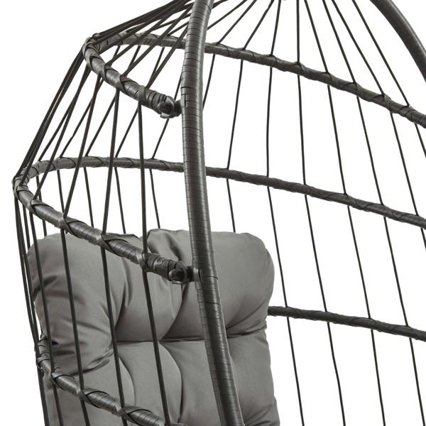 Black rattan hanging egg chair featuring a cushioned gray seat, woven texture, and an open, airy design perfect for relaxation