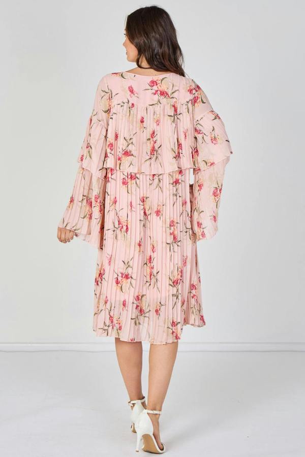 Woman wearing a pink floral dress on a white background