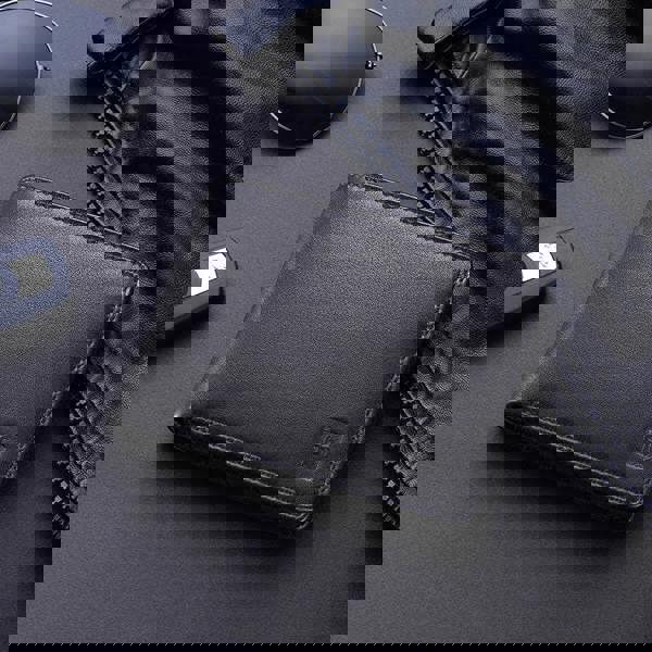 Lifestyle view of Black leather wallet with a brand logo