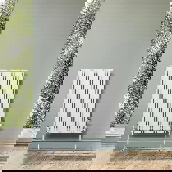 White oval single column radiator, 600 x 600mm, featuring a sleek design with polished chrome valves, set against a modern interior backdrop