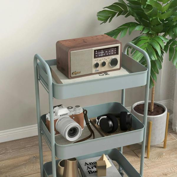 Light blue three-tier steel storage trolley with camera and media items on open shelves