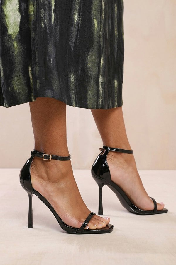 Where's That From Mila Strappy Stiletto Heel Sandal With Ankle Starp Closure in Black Patent