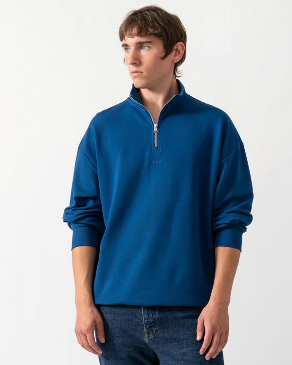 model wearing a HUGO Durty244 Mens 1/4 Zip Sweatshirt in Open Blue 498