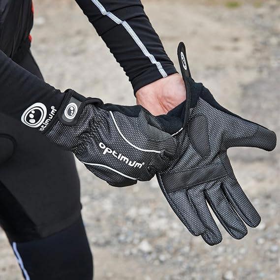 Person wearing black winter cycling gloves outdoors on gravel, adjusting the fit - Optimum