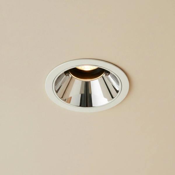 polished  chrome downlight mounted on the ceiling in a modern home 