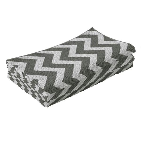 Folded reversible rug mat with light grey and white zigzag chevron pattern