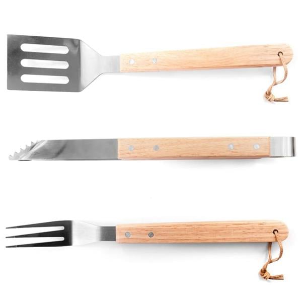 A high-angle shot of the three individual barbecue utensils showing the stainless steel spatula, serrated tongs, and carving fork with light timber handles on a plain white background.