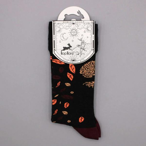 Black bamboo sock with scattered leaf pattern and tree-of-life graphic; burgundy toe