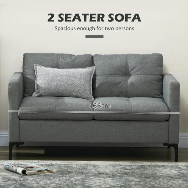 Dark grey two-seater sofa with tufted back cushions, padded seat, and steel legs