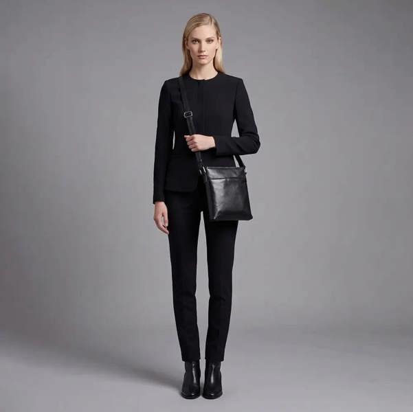 Women's black  leather cross body bag with adjustable shoulder strap
and multiple compartments.