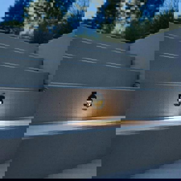 black outdoor stair light mounted in the stair riser of outdoor concrete steps 