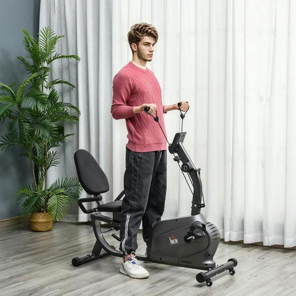 Black recumbent exercise bike with padded seat and backrest, shown with a standing user