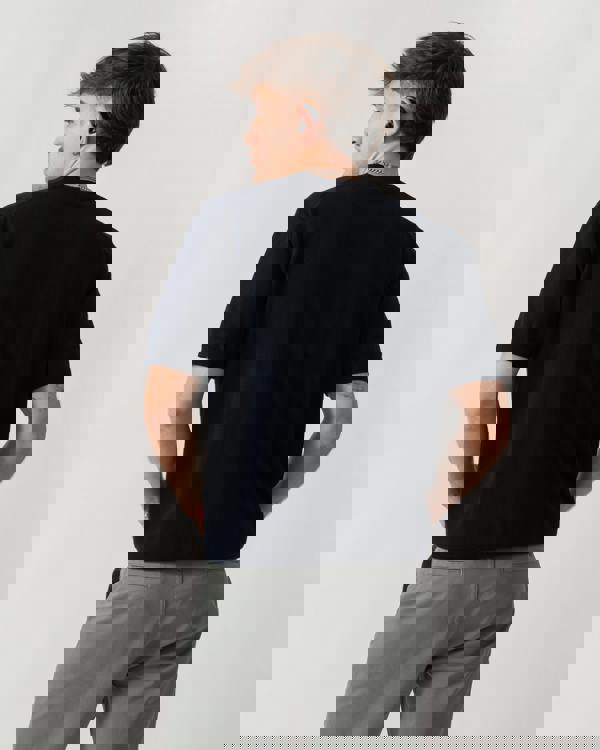 back shot of a model wearing a BOSS Orange Kanacho Mens T-Shirt in Dark Blue 404