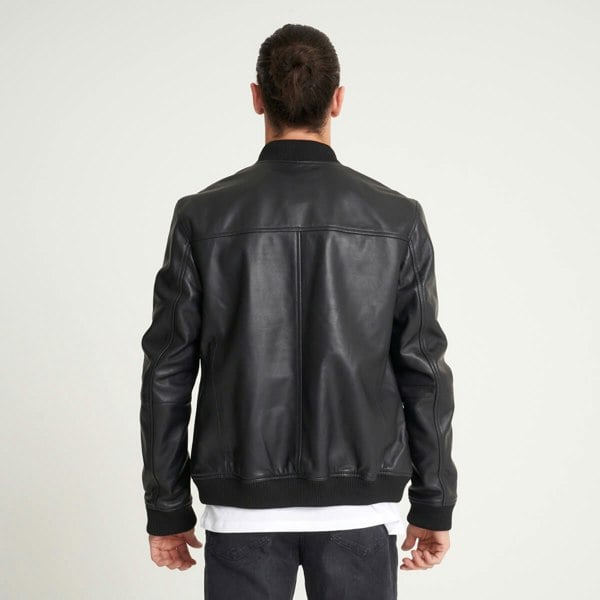 Image displays what the leather bomber jacket looks like from the back. It is black in colour with no patterns.