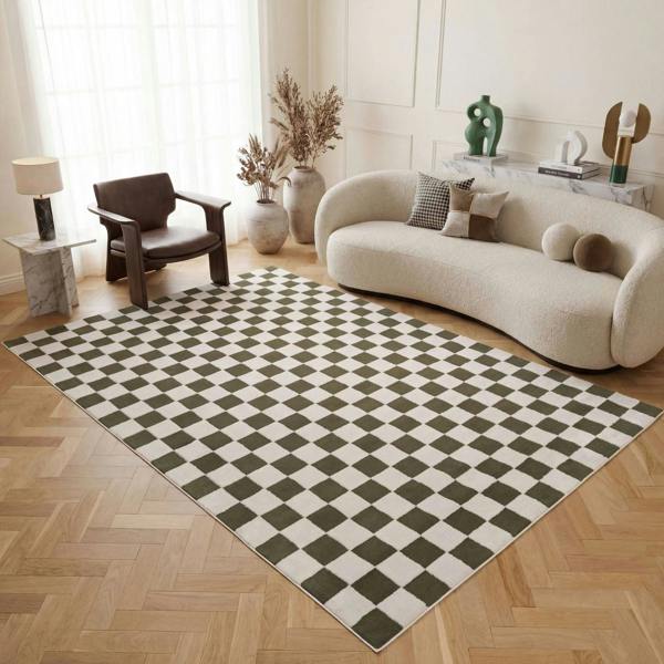 Living room with a checkered green and white rug, modern sofa, and armchair.