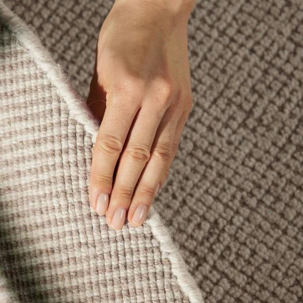 Close-up of a hand touching textured fabric