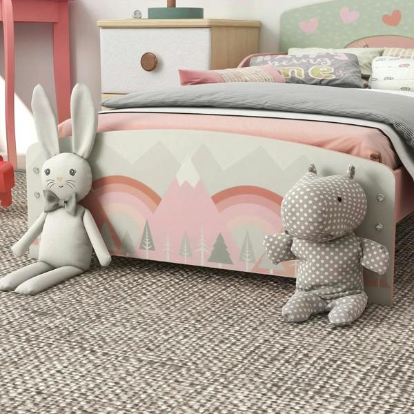 Pink toddler bed frame with illustrated side panel and standing plush toys on the floor