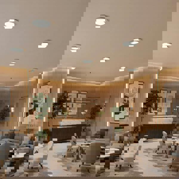 Slim downlight in a hotel reception with furniture against a pale orange wall