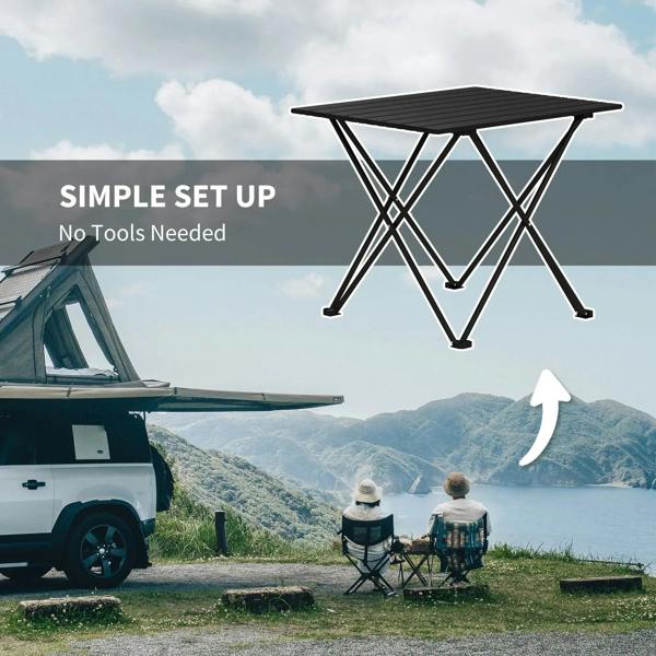 Folding camping table with black slatted tabletop and metal X-frame legs