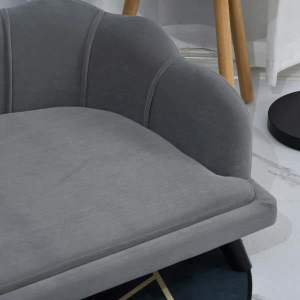 Grey cushioned side and armrest of a dog sofa with thick seat padding