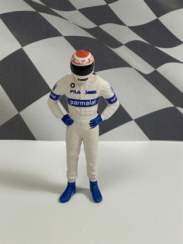 a toy figure of a race car driver