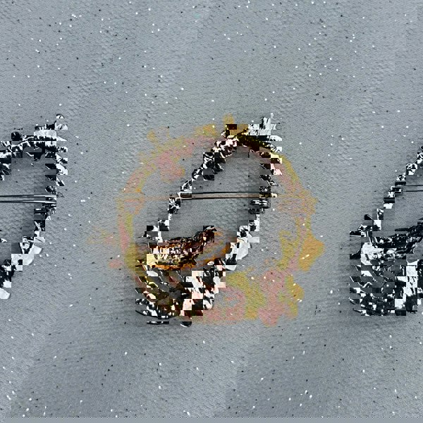 Vintage bird brooch, gold tone metal, multicolour enamel detailing, perched on floral garland branch, intricate nature inspired jewellery, statement accessory, elegant gift for her
