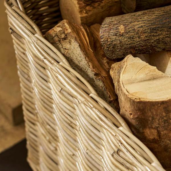 Top view angle showing the spacious interior of the handwoven grey kubu rattan log basket filled with cut wooden logs.